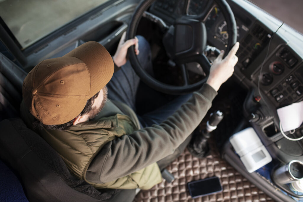 Driver in his vehicle delivering parcels